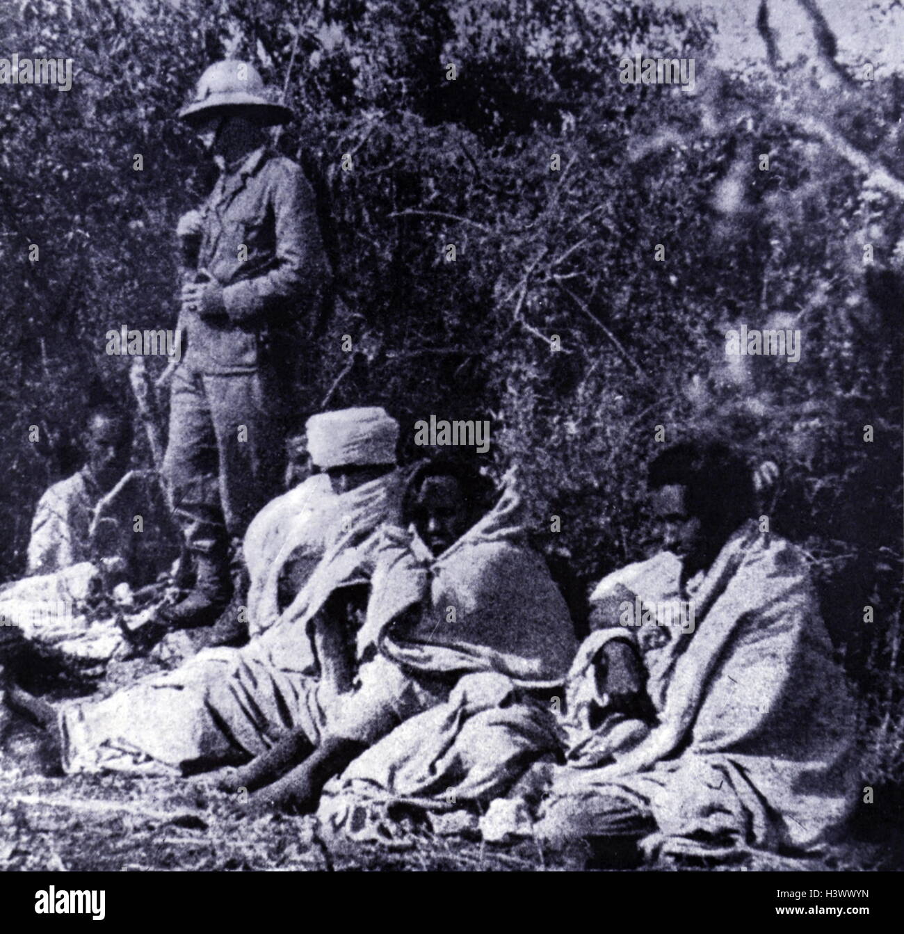 Captured Ethiopian soldiers gaurded by an Italian soldier during the Abbysinian War 1936 Stock Photo
