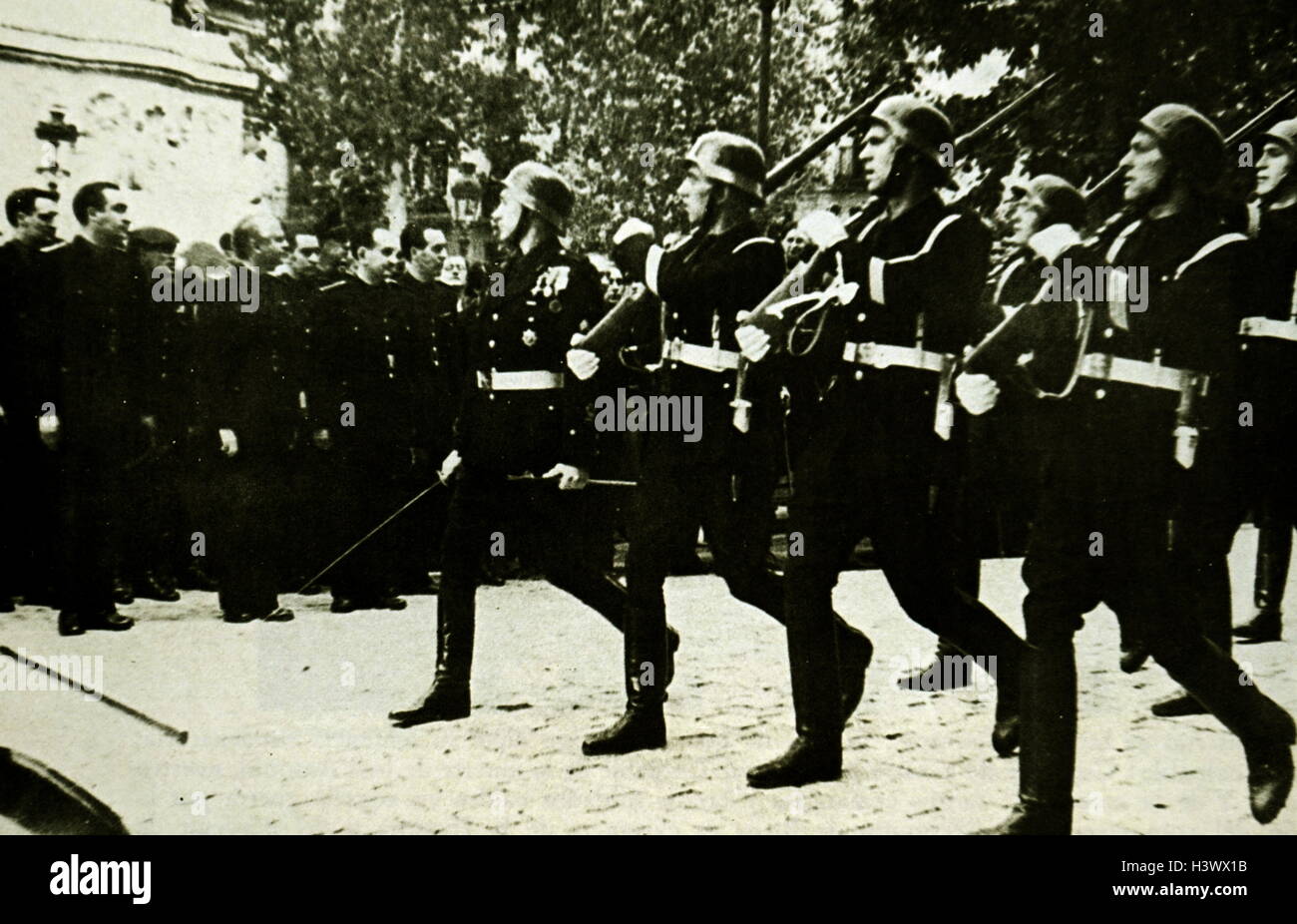 Photograph of Militias F. E. T. and J. O. N. S. parading through the streets of Madrid. Dated 20th Century Stock Photo