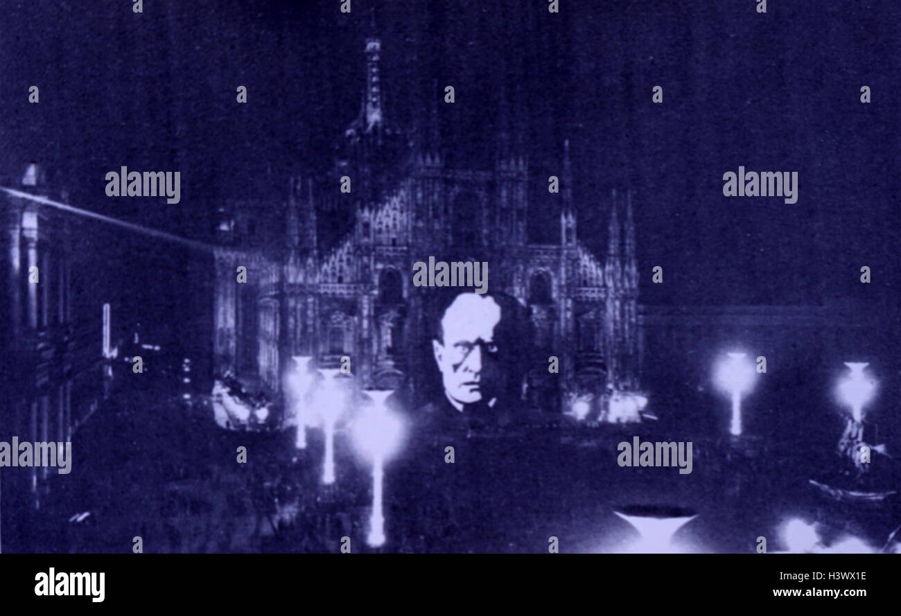 The face of Italian fascist leader Mussolini is projected onto the front of Milan Cathedral 1936 Stock Photo