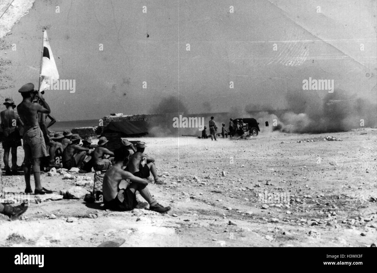 Photograph of an Anti Tank Platoon practice with a 17 pounder by firing out to sea as part of their preparation to join 40 Royal Marine Commando for the Suez Landing. Dated 20th Century Stock Photo