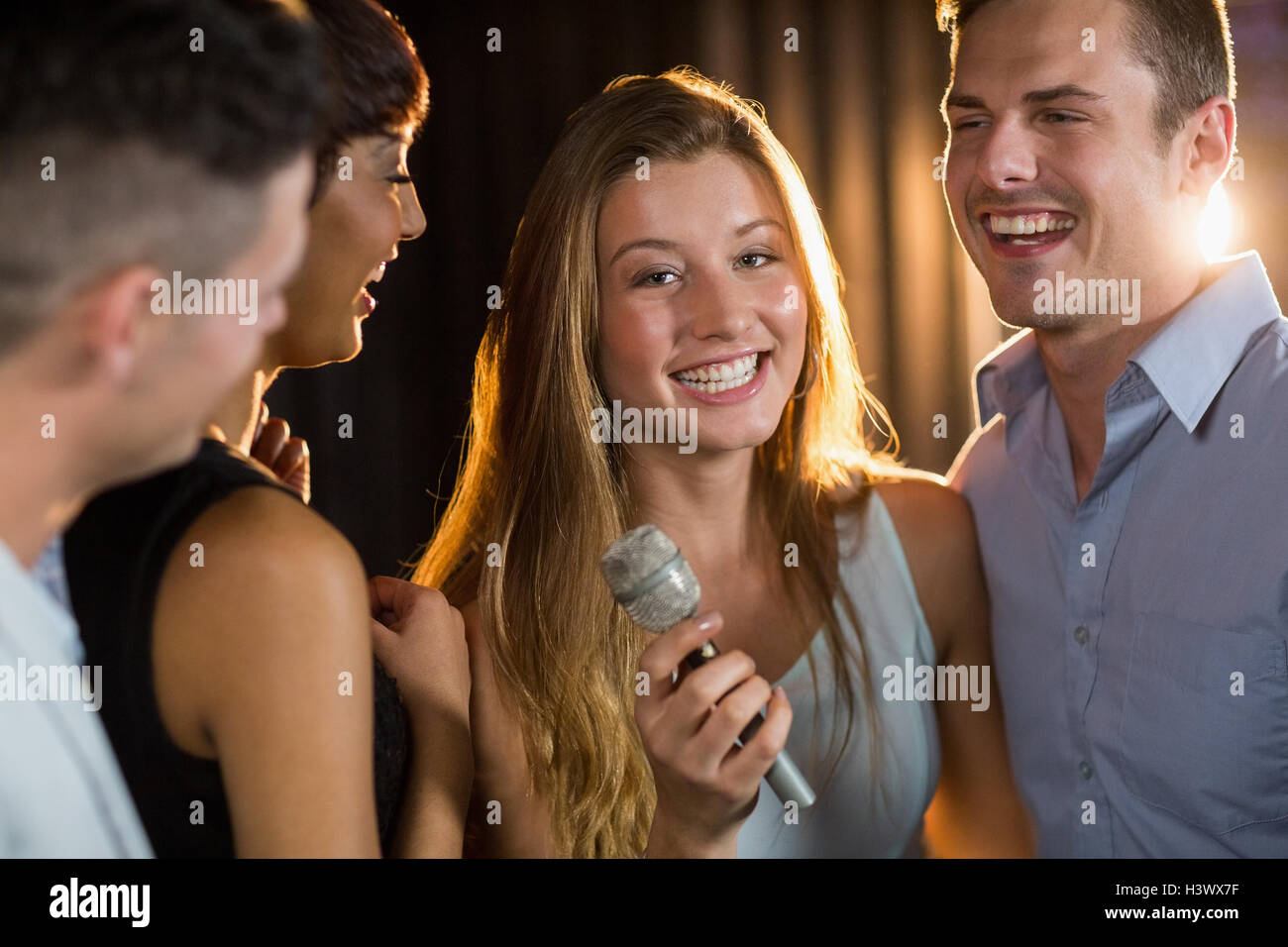 Happy friends singing song together Stock Photo