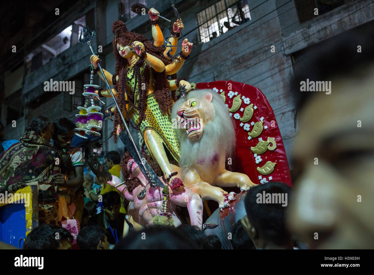 Dhaka, Bangladesh. 11th October, 2016. Bangladeshi Hindu devotees immerse an idol of Hindu Goddess Durga into the river Buriganga in Dhaka, Bangladesh, on October 11, 2016. The five-day Durga Puja festival commemorates the slaying of a demon king Mahishasur by Hindu goddess Durga, marking the triumph of good over evil. Credit:  zakir hossain chowdhury zakir/Alamy Live News Stock Photo