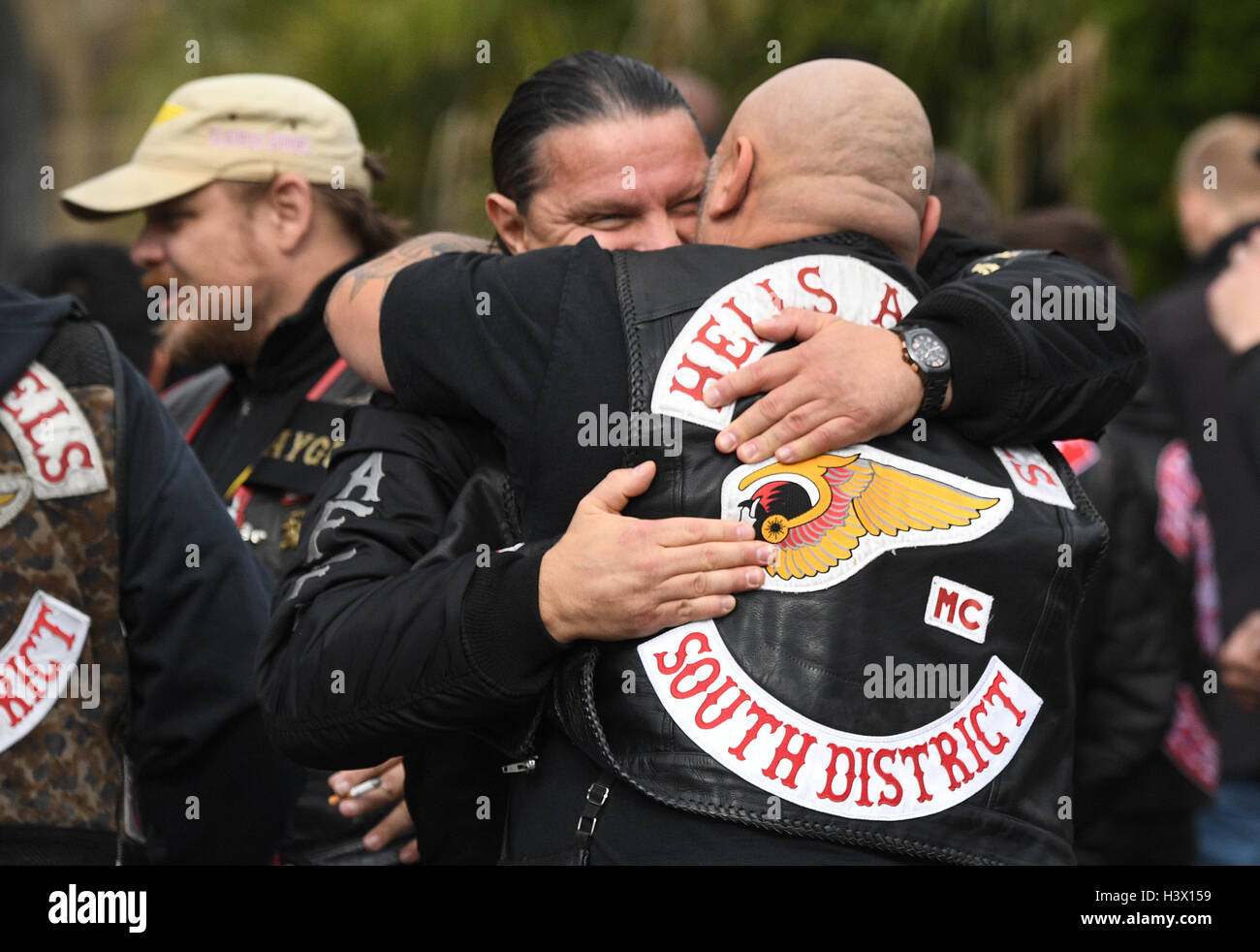 Giessen, Germany. 12th Oct, 2016. Hells Angels and members of befriended rocker clubs from several European countries and the whole federal state stand in front of the Neue Friedhof graveyard in Giessen, Germany, 12 October 2016. The funeral of the Hells Angels Giessen president, Aygun Mucuk, who had been shot dead, took place there. PHOTO: BORIS ROESSLER/dpa/Alamy Live News Stock Photo