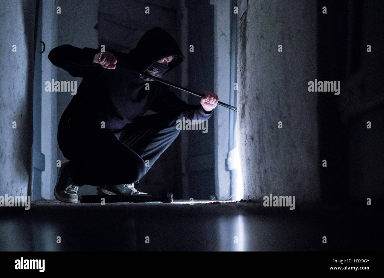 Rottweil, Germany. 8th Oct, 2016. ILLUSTRATION - A ficticious burglar breaks open a door with a jemmy in the basement of a residential house in Rottweil, Germany, 8 October 2016. PHOTO: SILAS STEIN/dpa (staged scene) © dpa/Alamy Live News Stock Photo