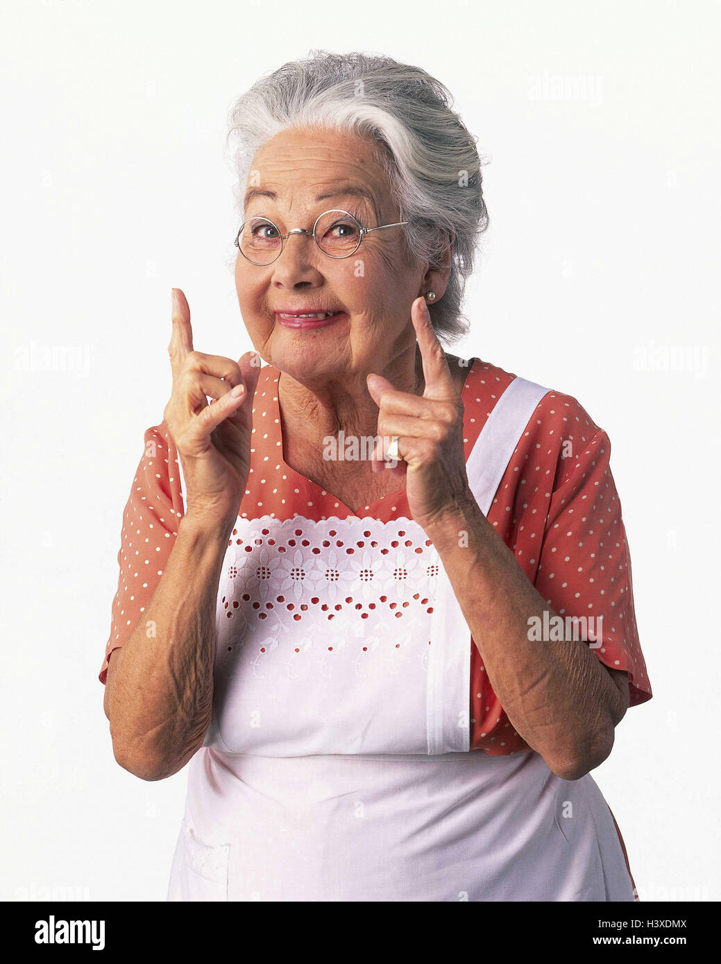 Senior, apron, gesture, finger, measurement, size display, half portrait, Senior, inside, cut out, woman, old, hairs, grey, glasses, granny, housewife, smile, indicate distance, studio, Stock Photo