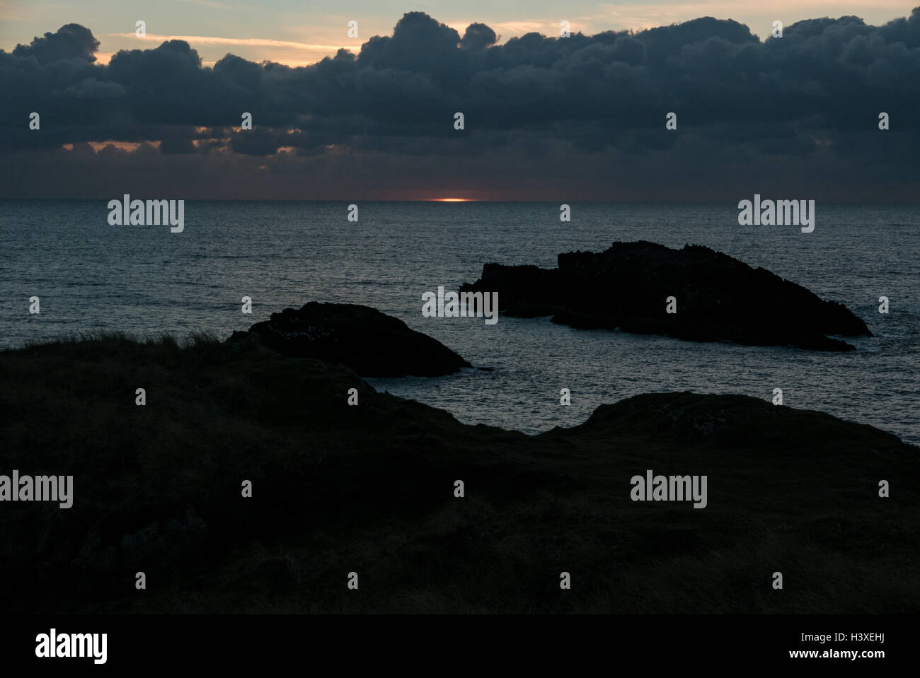 Last light burns on the sea off Anglesey Stock Photo