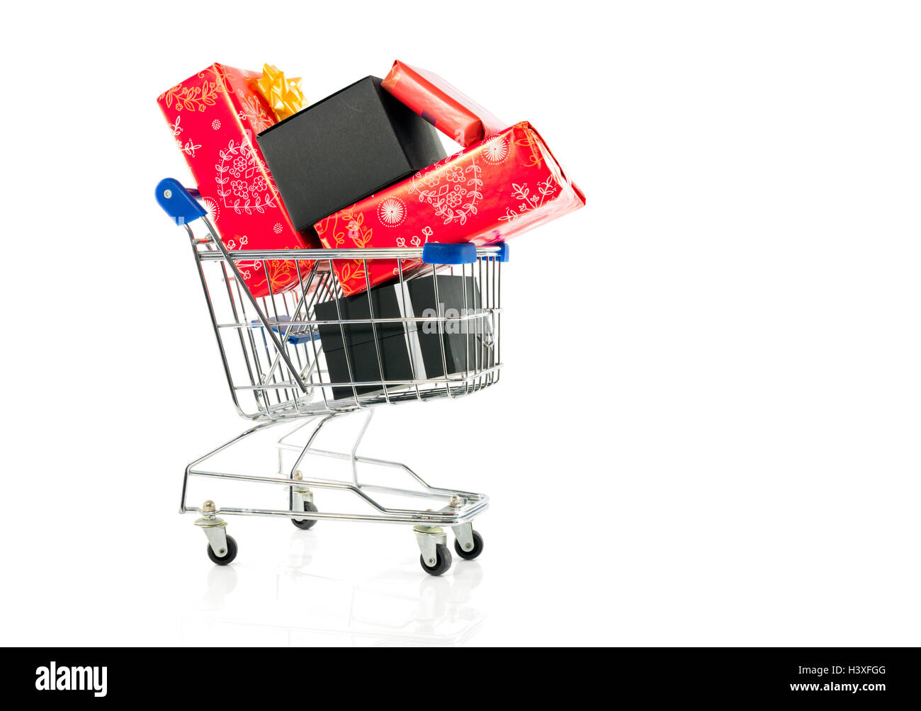 paying the presents in the shopping cart with credit card of bank card Stock Photo
