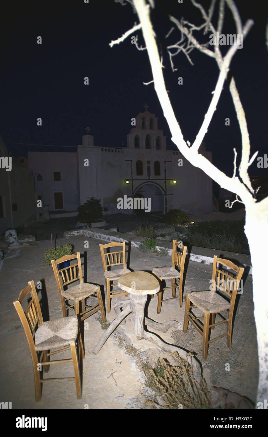 Greece, Santorin, church, forecourt, table, chairs, tree, detail, night sandy soil, mysticism, secret, lighting, tree, roots, outside Stock Photo