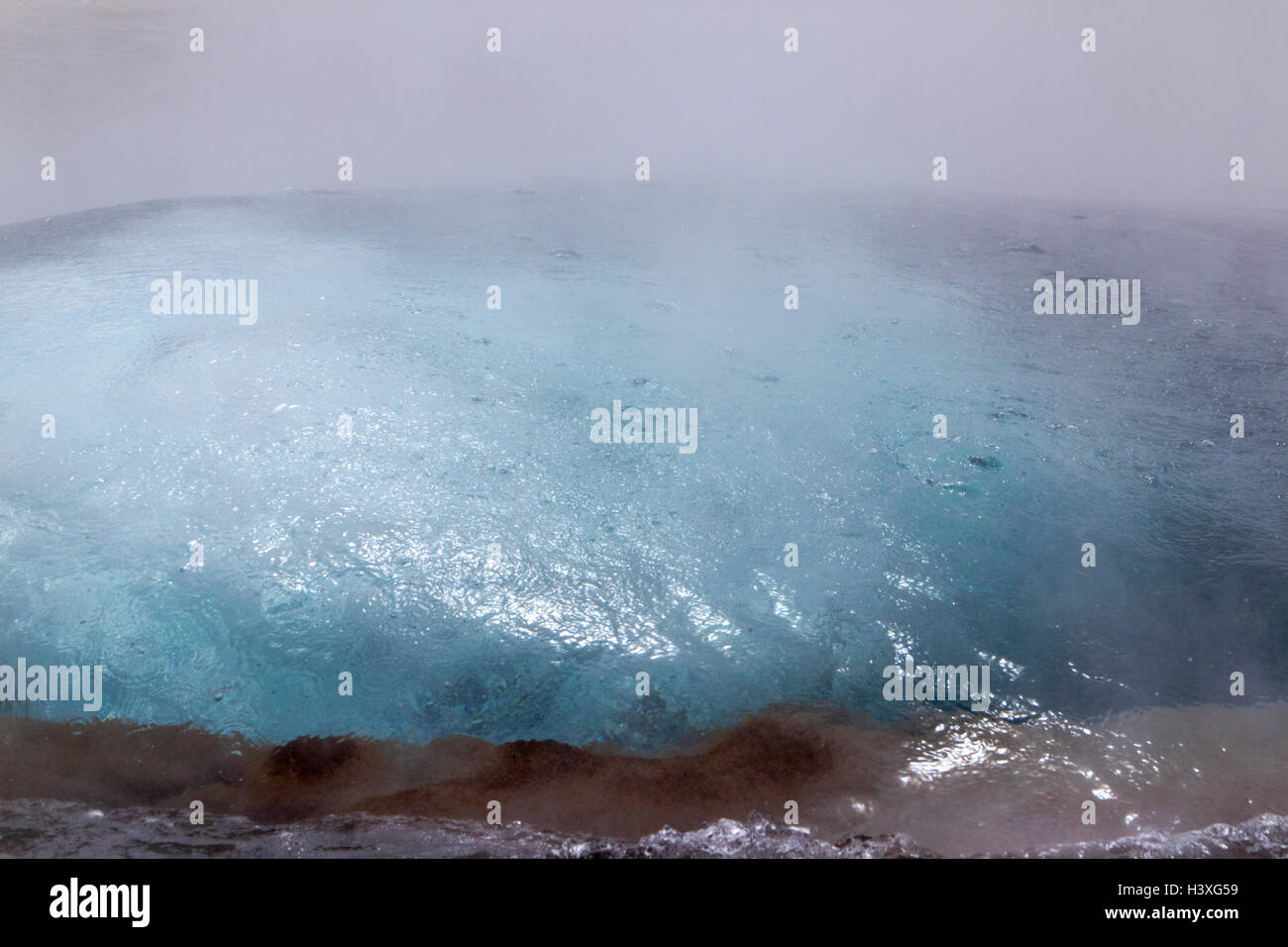 steam boiling up as strokkur geyser erupts phases geysir Iceland Stock Photo