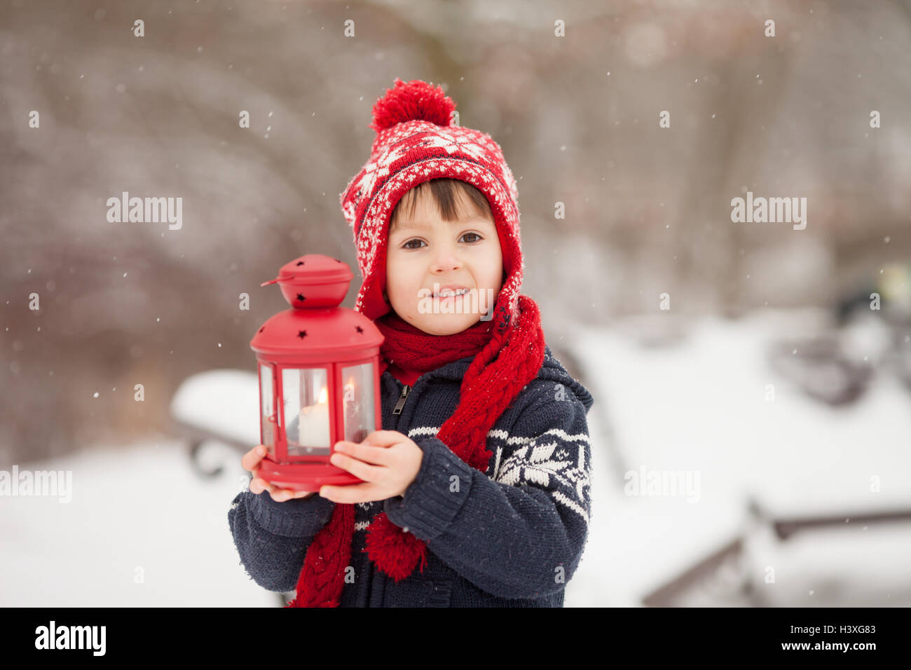 Cute little caucasian boy with teddy bear and red lantern, playing in ...