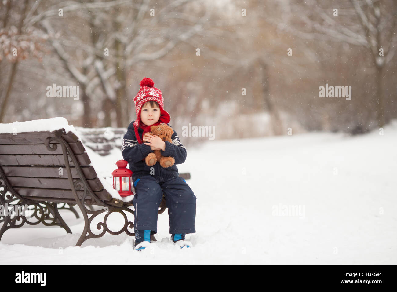 Cute little caucasian boy with teddy bear and red lantern, playing in ...