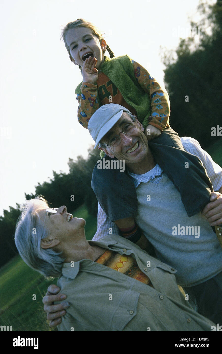 Grandparents, granddaughter, shoulders, carry, walk, very close, outside, couple, granny, grandpa, girls, grandchild, granddaughter, child, walking go, laugh, happy, cheerfulness, fun Stock Photo