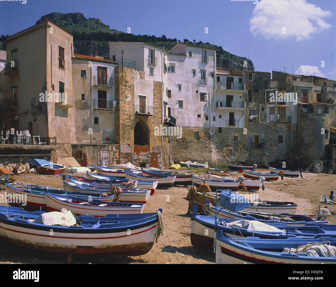 Italy, Sicily, Cefalu, Old Town, Europe, beach, boots, blue, houses, cloudy sky, outside Stock Photo