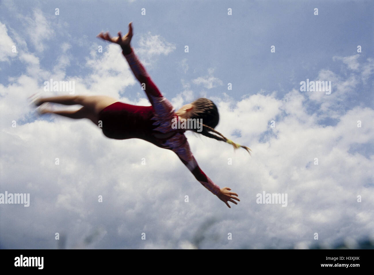 Art gymnastics, girl, somersault, outside, cloudy sky, child ...