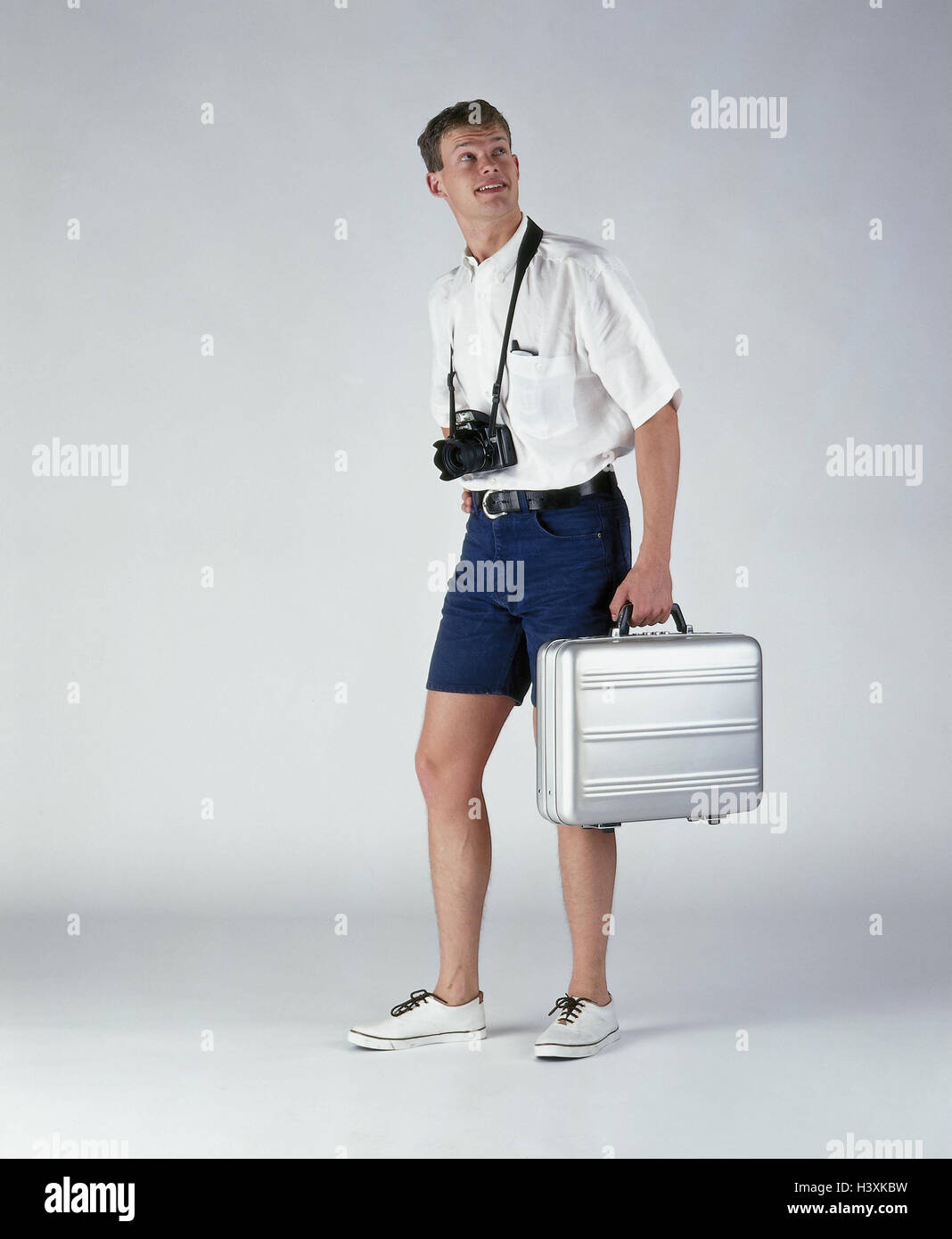 Man, young, shorts, linen shoes, camera, briefcase, studio aluminium