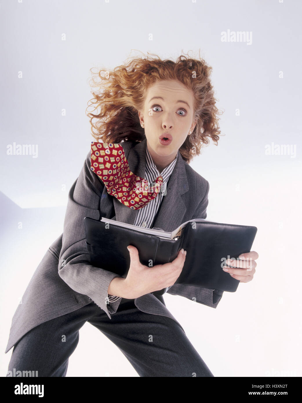 Businesswoman, dynamically, personal organizer business, dynamics, woman, suit, tie, red-haired, facial play, inside, studio Stock Photo