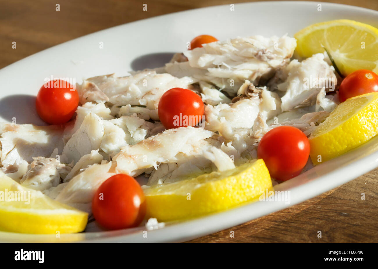 grilled cod  with lemon and chery tomatoes salad Stock Photo