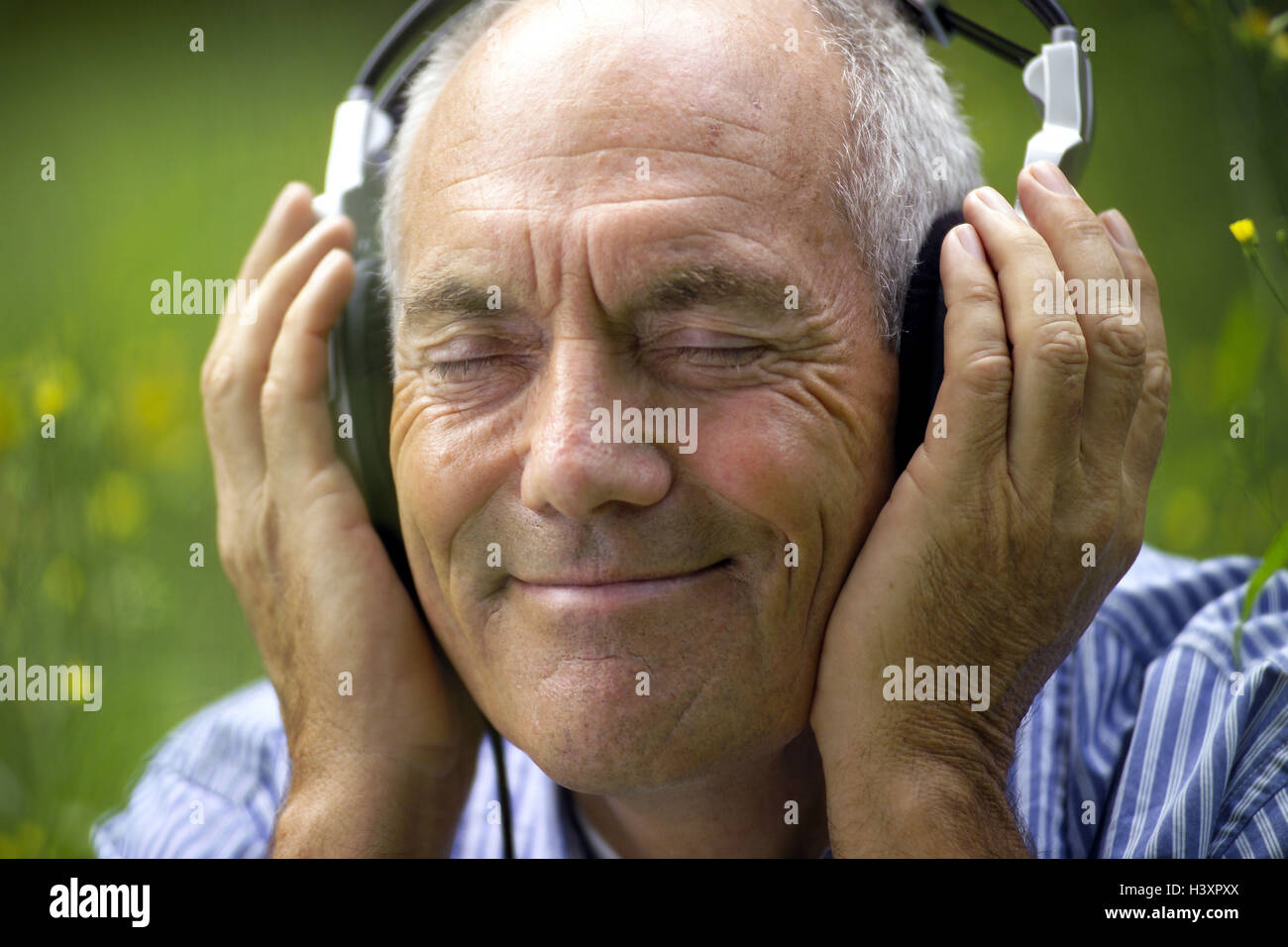 Senior, eyes closed, earphone, music hear, enjoy, portrait, outside, man, senior citizens, old person, pensioner, retirement, 60-70 years, time, time out, leisure time, Best Age, hobby, music, music hearing, recreation, is relaxing, smile, consumption, expression, happy, carefree, lighthearted, satisfaction, take it easy, music lover, attitude to life, old age pension, lifestyle, meadow, summer, nature, man's portrait, Ti3 Stock Photo