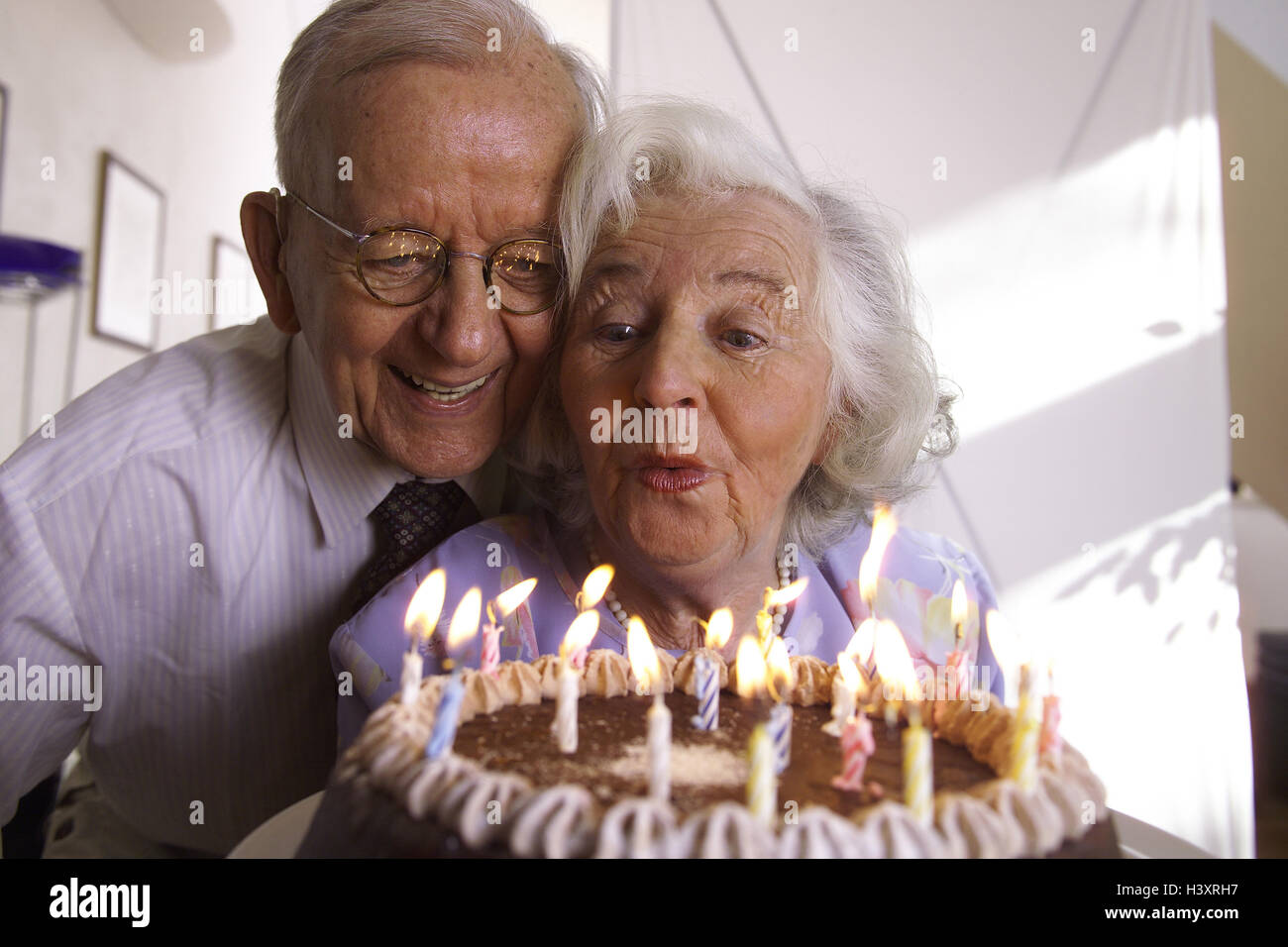 Senior citizen's couple, birthday cake, candles blow out, joy, luck, portrait, senior citizens, couple, pensioner, old person, 70-80 years, homes, partnership, friendship, luck, harmony, happily, falls in love, celebrate carefree, contently, actively, together, common characteristic, closeness, love, affection, tenderness, surprise, birthday surprise, birthday, birthday cake, cake, cake, birthday candles, wish, Stock Photo
