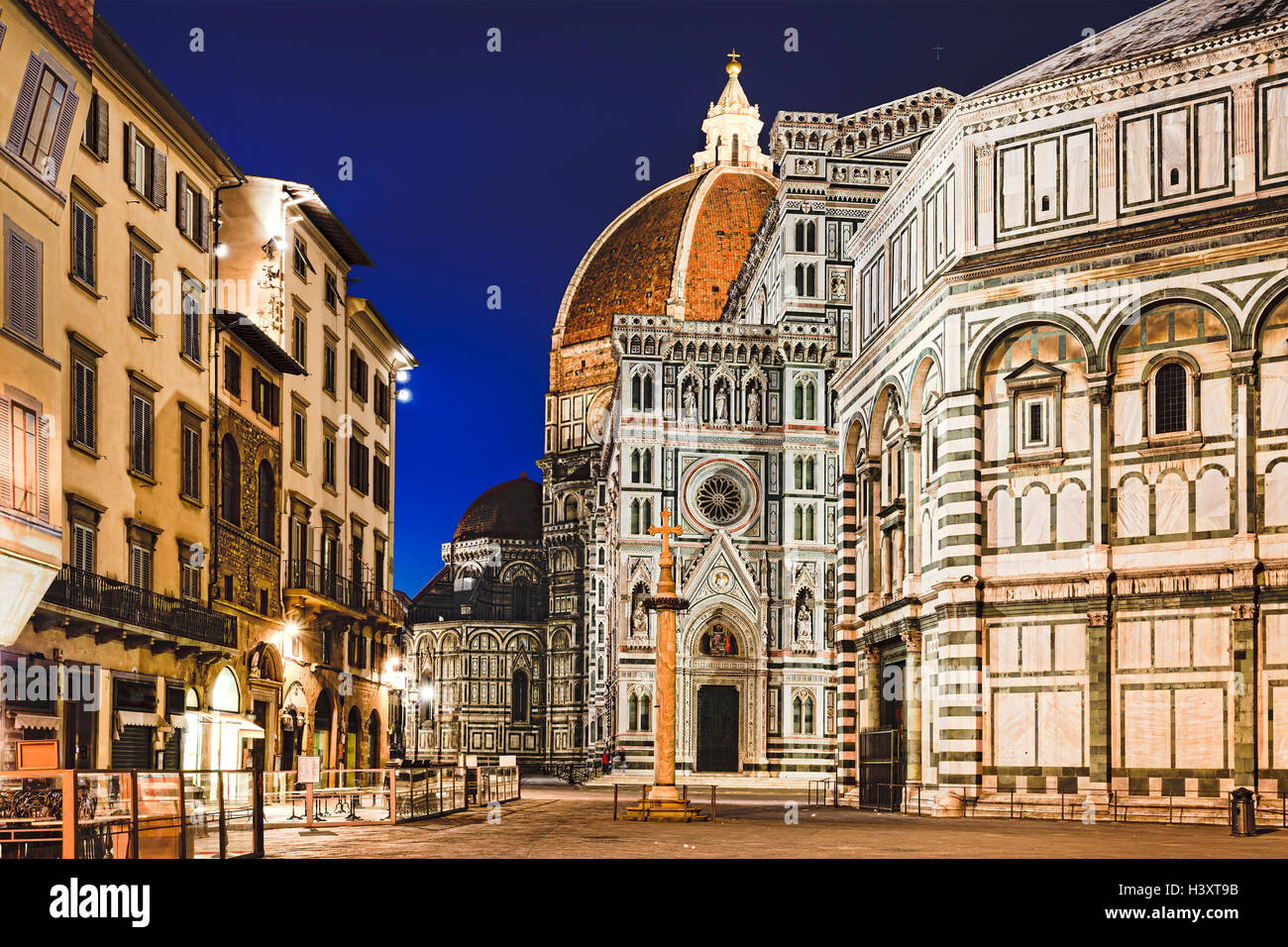 Santa Maria Del Fiore cathedral of Florence, Italy, at sunrise. Close-up view of facade entrance, dome and baptistery from empty Stock Photo