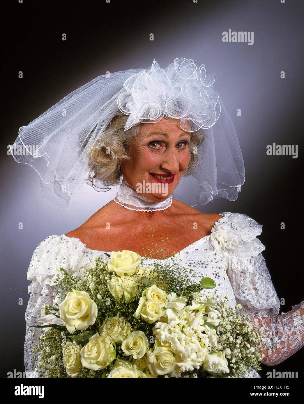Bride, senior, wedding dress, veil, bridal bouquet, facial play, portrait,  Senior, studio, inside, woman, old, wedding, marry, Before, marriage  ceremony, marriage, marry, old person, luck, joy, smile, mischievously,  request, near Stock Photo 