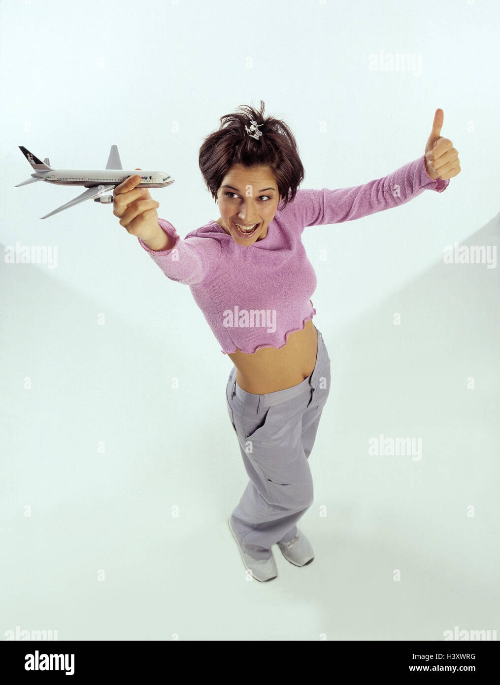 Woman, young, bare midriff, model airplane, hold up, gesture, pollex