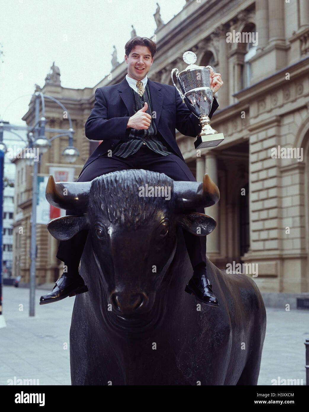 Germany, Frankfurt, stock exchange, sculpture, bull, man, sit, cup, gesture, victory, profit bull and bear, bull market and slump, icon, pollex, high, okay, success, successfully, stocks, stock market, winner's cup Stock Photo