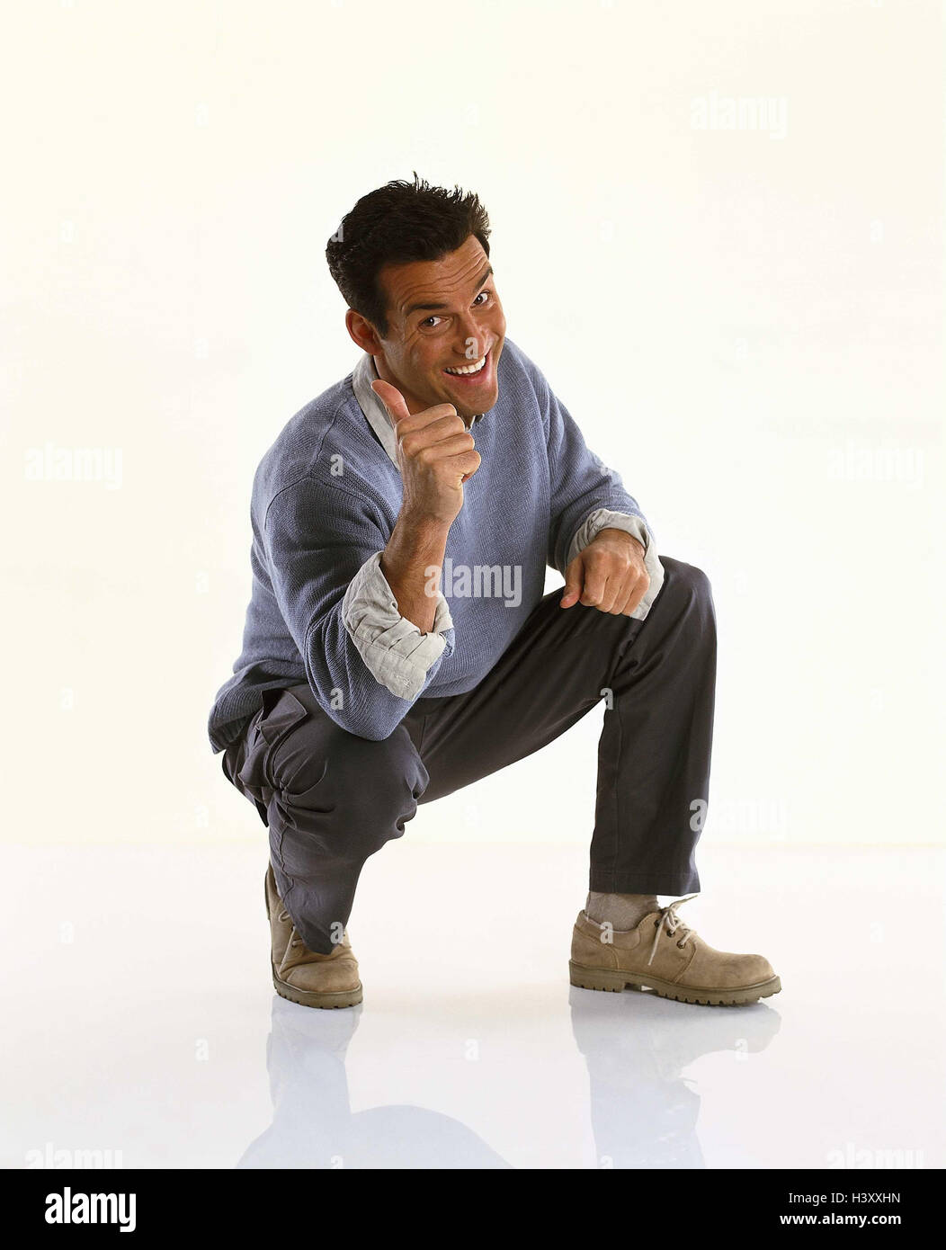 Man, young, squat, gesture, pollex, high, okay, Men, cut outs, studio, smile, near, body language, point, one indicate, number, in order, okay, positively, well, success, Stock Photo