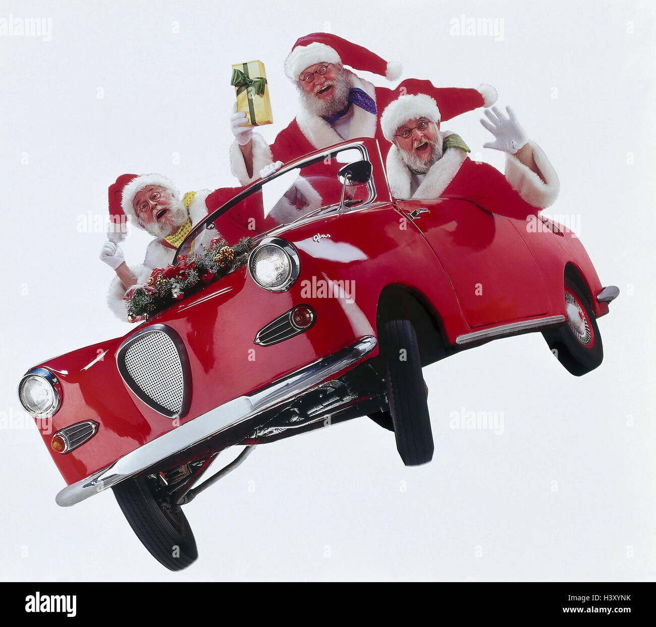 Santas, car, old-timer, facial play, joy, enthusiasm studio, cut out, Christmas, Christmas, Santa Claus, Santa, men, three, presents, deliver, delivery, car, 'glass', cabriolet, happy, wave Stock Photo