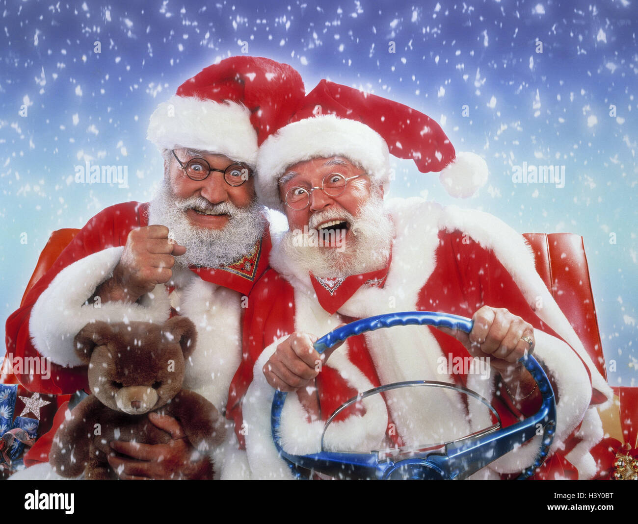 Santas, presents, motoring, convertible, gesture, joy, snowfall Christmas, Santa, two, packages, car, teddy bear, studio, transport, promotion, drive, happy, funnily Stock Photo