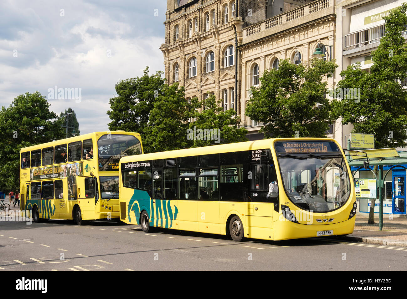 Yellow Buses at a bus stop in the city centre. Bournemouth, Dorset, England, UK, Britain Stock Photo