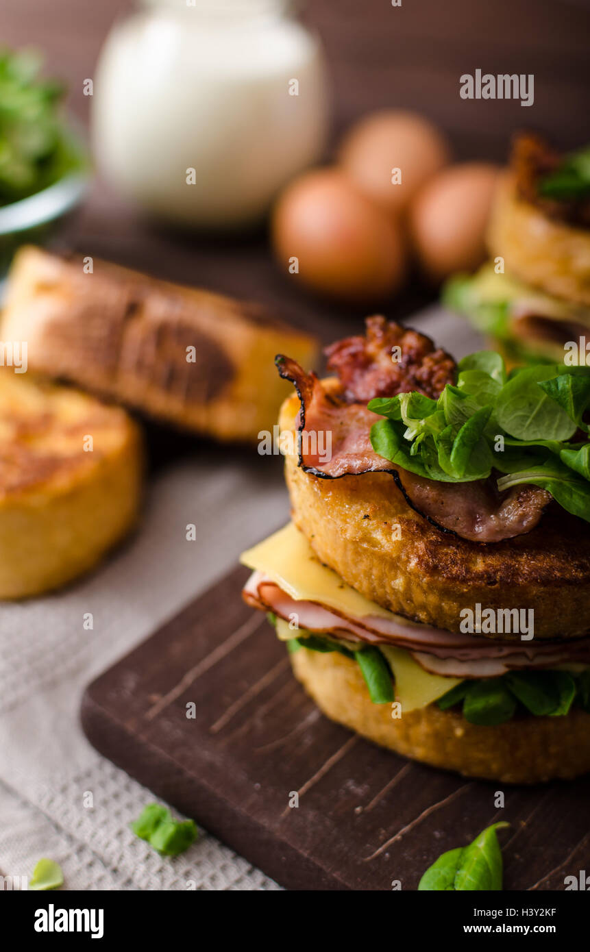 French toast with homemade ham, crispy bacon and salad, gouda cheese