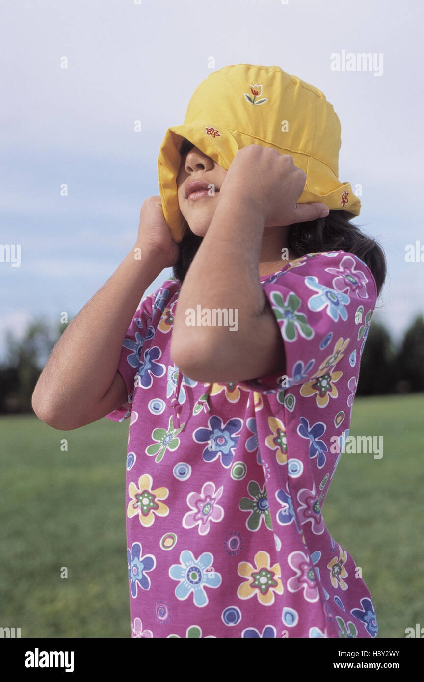 Girls, solar hat, look, cover, half portrait, outside, leisure time, childhood, fun, 9 years, headgear, care, substance hat, runterziehen, pull down, hide, play, shyly, ashamed, embarrassed Stock Photo