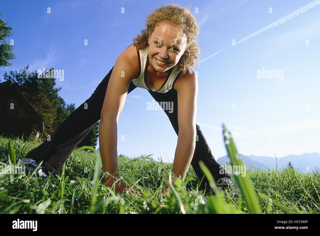 Meadow, woman, young, gymnastics, stretching, model released, outside, leisure time, hobby, sport, fitness, gymnastics practise, distension practise, Stretching, stretch, motion, vitality, activity, training, train, upper part of the body, prevent, feet, spread Stock Photo