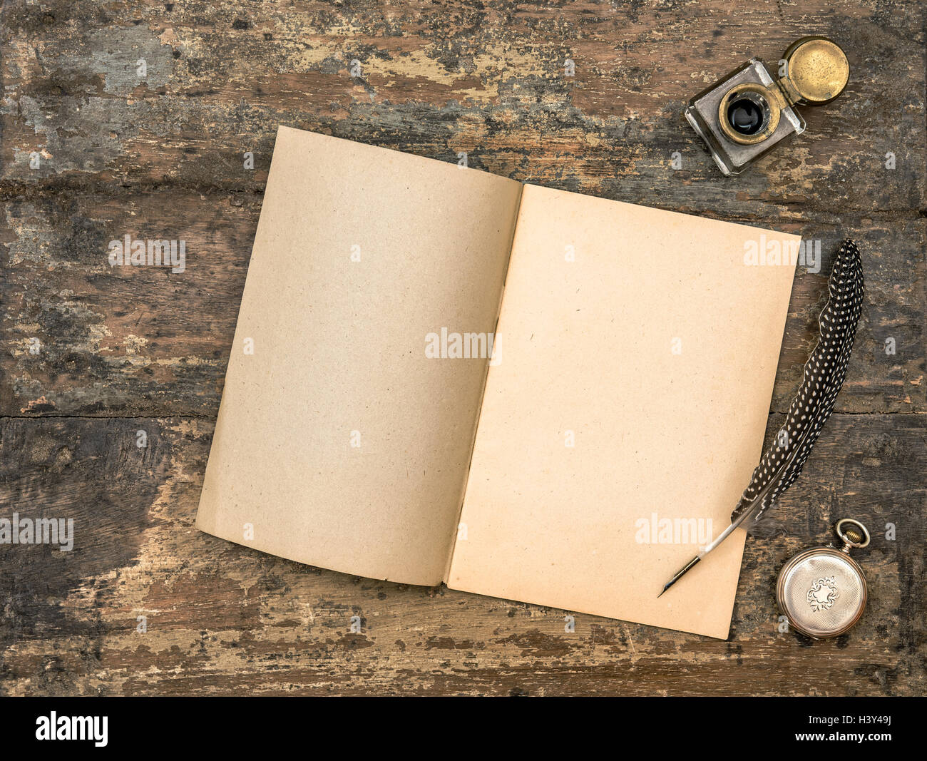 Open diary book and vintage office supplies on wooden table Stock Photo