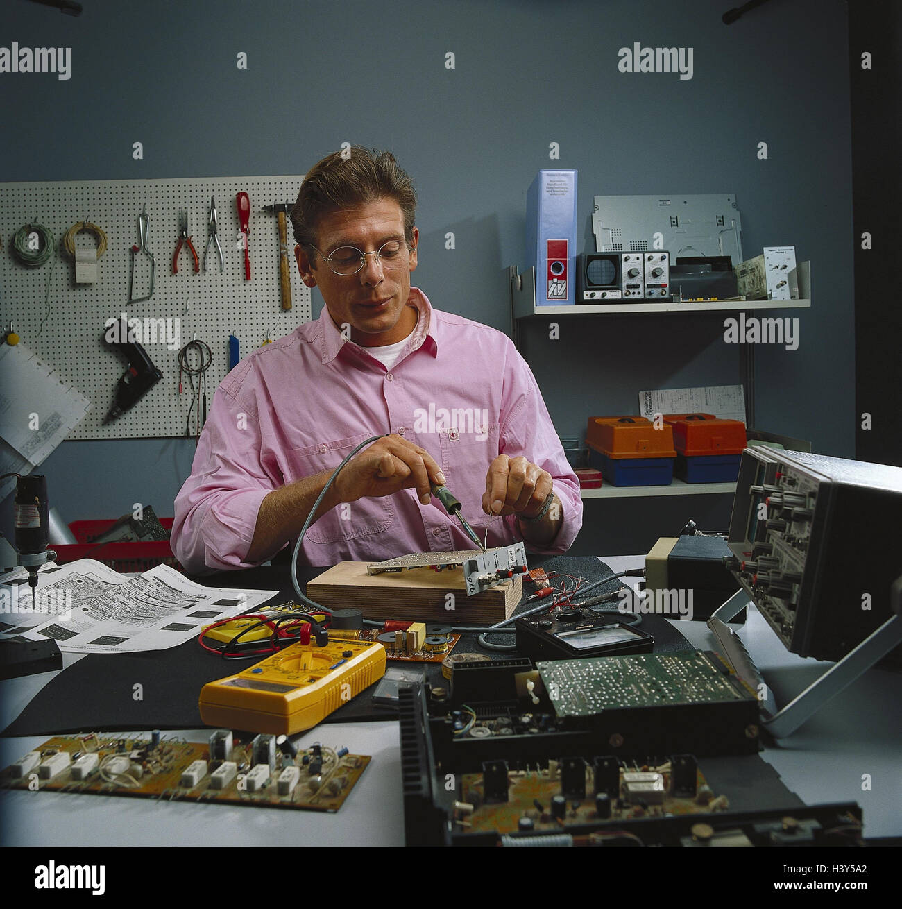 Garage, man, electrical appliance, soldering inside, doityourselfer