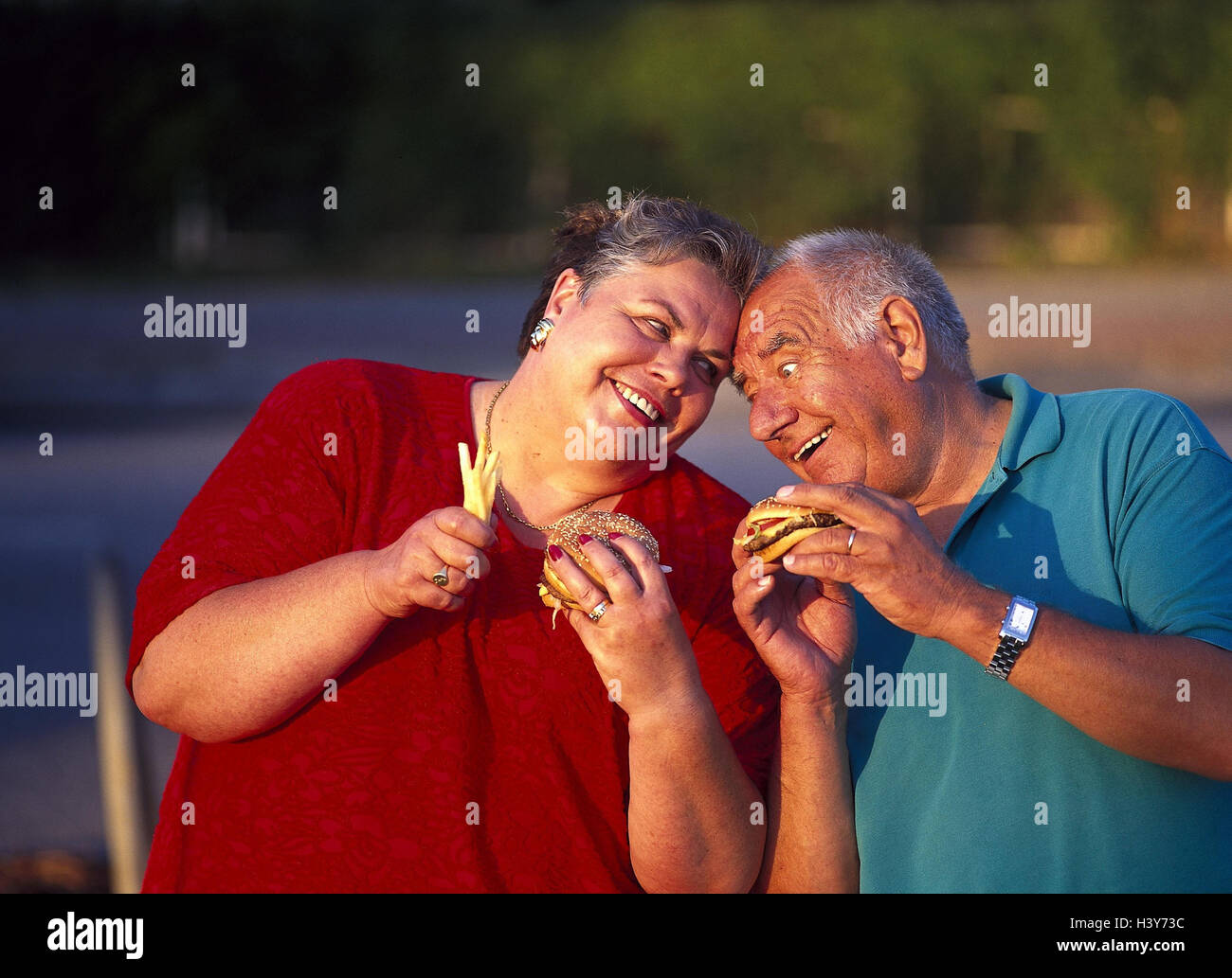 Senior couple, thickly, happy, fast food, cheeseburgers, chips, eat