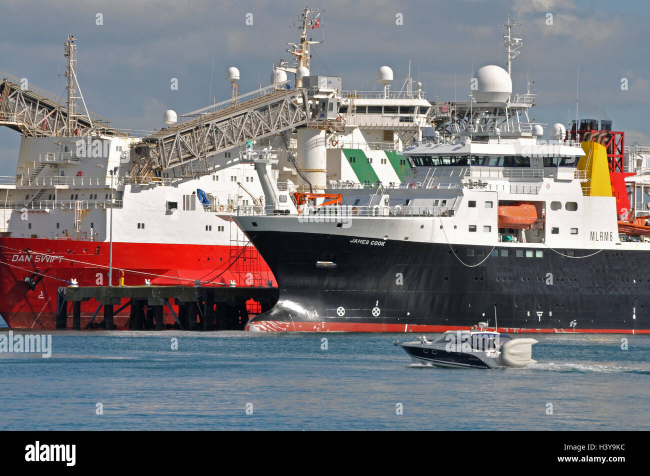 A small boat crosses in front of Falmouth docks Stock Photo