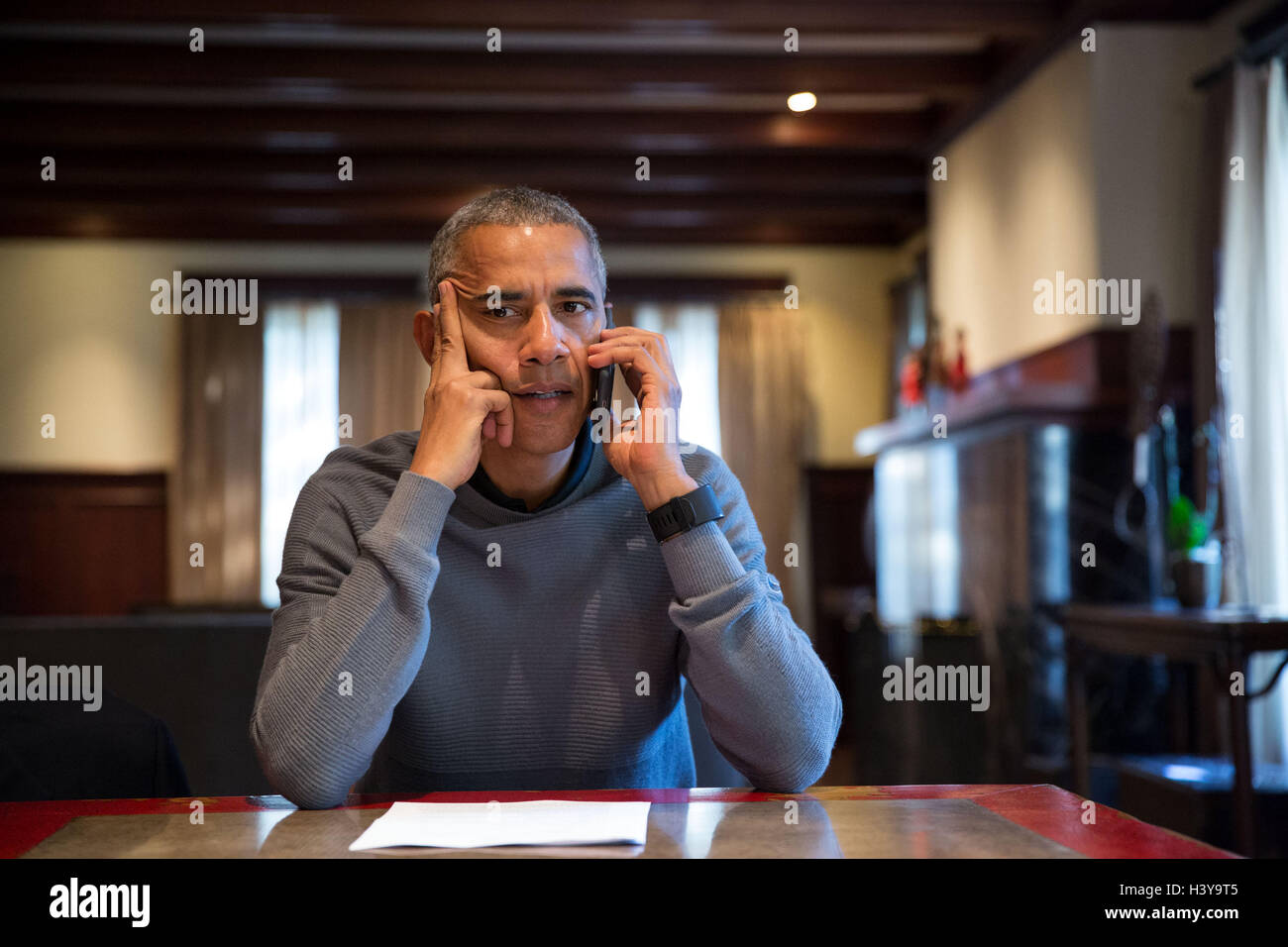 U.S President Barack Obama speaks on the phone from his home in Chicago with FEMA Administrator Craig Fugate to receive an update on Hurricane Matthew October 8, 2016 in Chicago, Illinois. Stock Photo