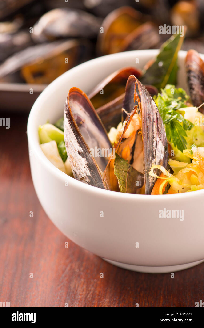 Roasted clams with asian coleslaw. Seafood dish served. Rustic gourmet shellfish dinner. Stock Photo