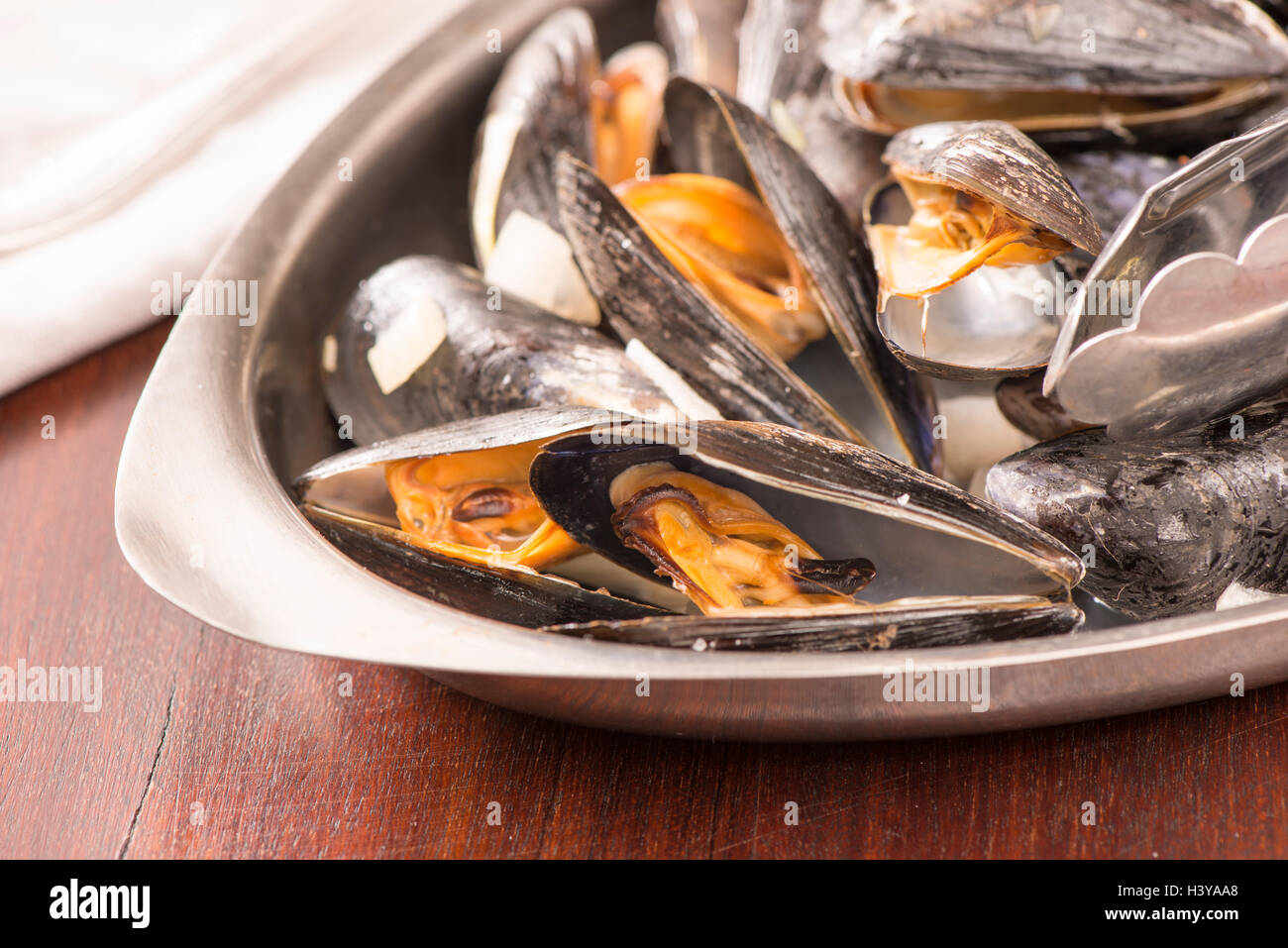 Roasted clams in close up. Seafood dish served. Rustic gourmet shellfish dinner. Stock Photo