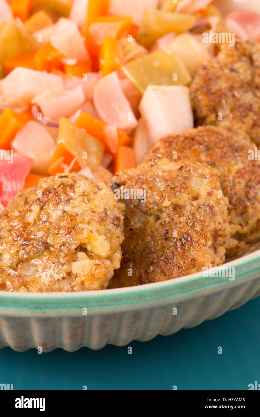 Veggie burger made of almond, lentil and halloumi. Vegetarian fried fast food with vegetables. Meat free and healthy eating. Stock Photo