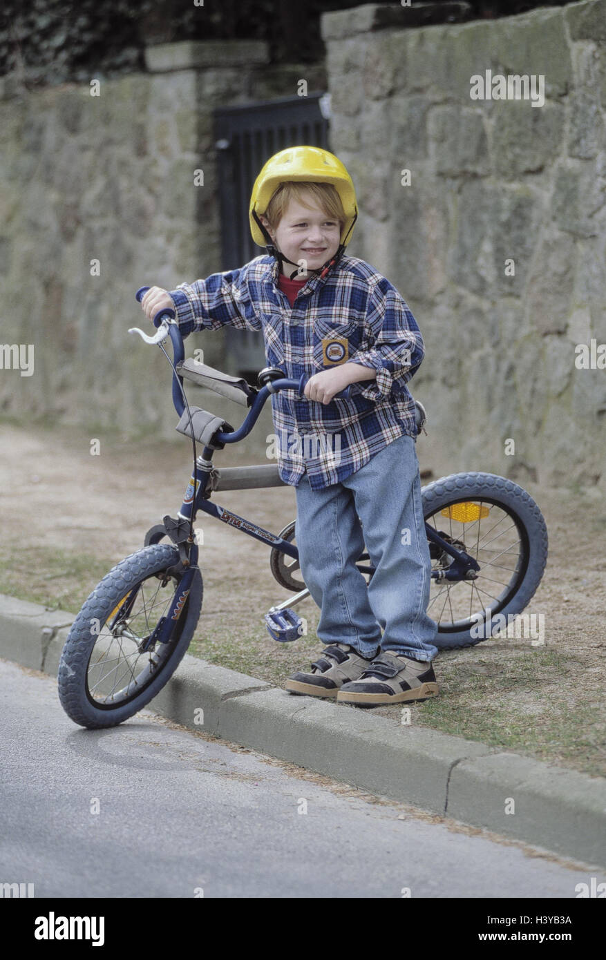 Roadside, boy, helmet, bicycle, pavement, cross, outside, street, sidewalk, side the street, change, child, 6 years, road users, radian, leisure time, childhood, danger, dangerously, danger situation, carefully, attention, safety helmet, hard hat, bicycle Stock Photo