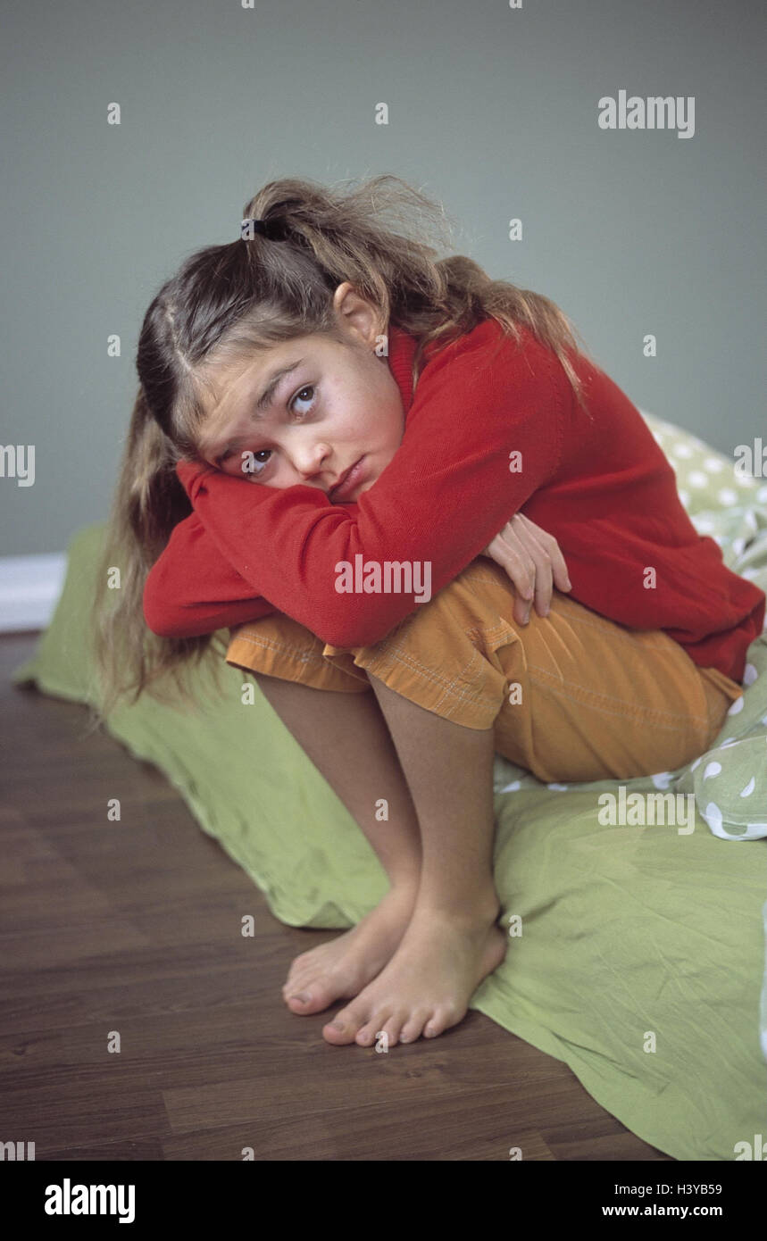 Bed, girl, sit, sadly, inside, child, 9 years, depresses, worries, dealted with, worried, thoughtful, grief, sorrowfully, melancholy, melancholia, unhappily, expression, mood, negatively Stock Photo