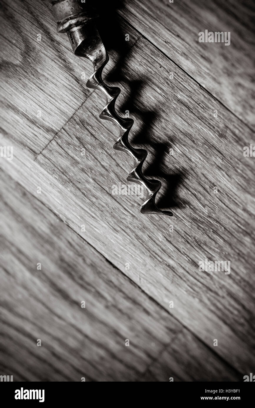 Corkscrew on wooden table in close up. Top view and copy space. Stock Photo