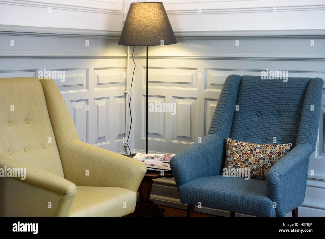 Two armchairs and a floor lamp on a reading corner Stock Photo