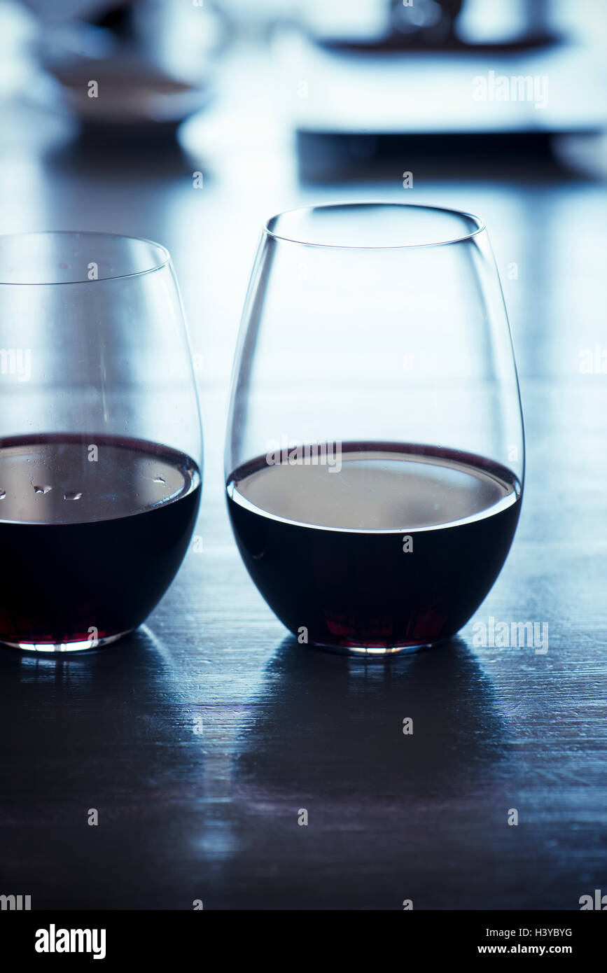 Two glasses of red wine on table. Restaurant or bar setting. Stock Photo