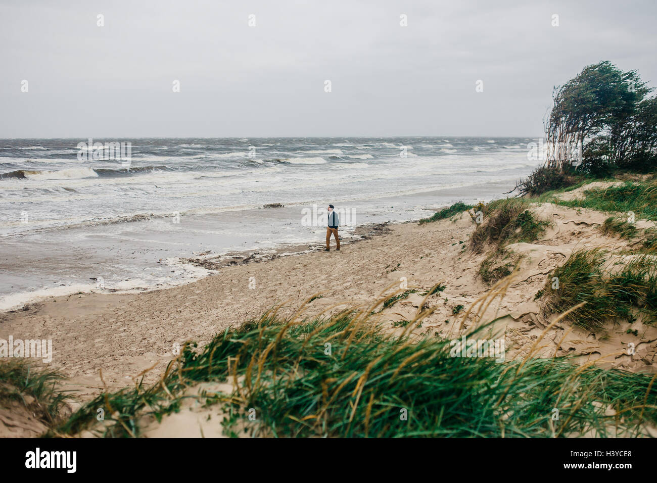Man walks alone along sea hi-res stock photography and images - Alamy