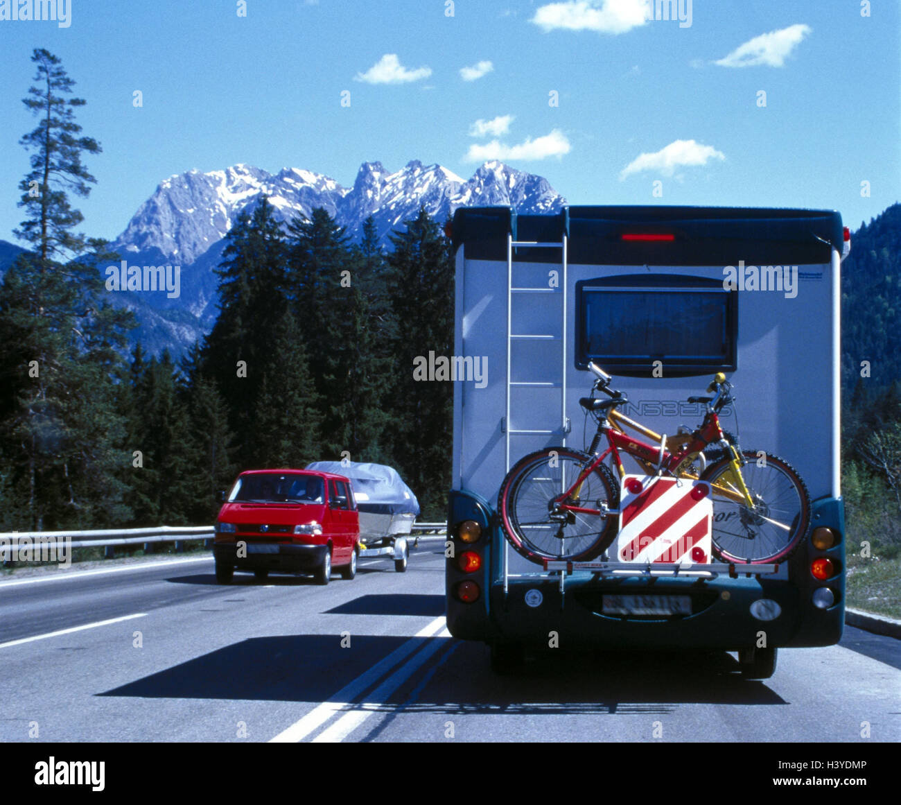Federal highway, traffic, two-way traffic, hard shoulder, camper, back view, scenery, mountains, street, traffic, autorice, vacation, holiday trip, passenger car, car, trailer, boat trailer, boot Stock Photo