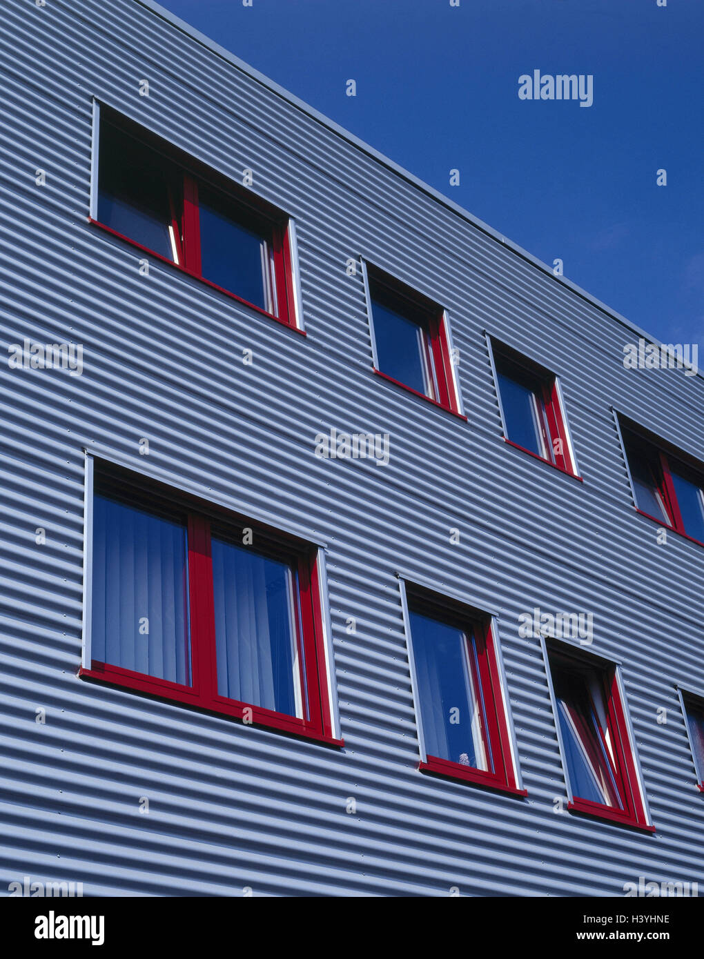 Corrugated iron facade of office building with office window hi-res